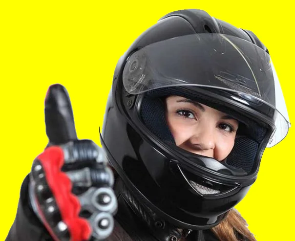 Motorcycle student wearing a helmet giving a thumbs up